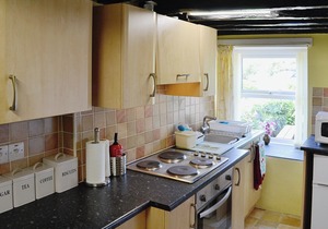 A cosy cottage for four with a wood burner and large, shared garden.