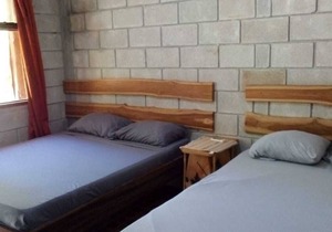 A rustic lodge surrounded by garden, nestled in a jungle setting - double Room 1