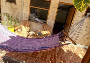 A rustic lodge surrounded by garden, nestled in a jungle setting - double Room 1