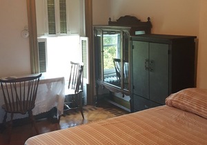 BEDROOM # 1 WITH AN EVENT SPACE AND BACK PORCH