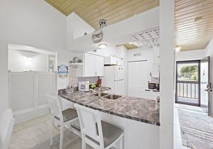 End unit condo w/two pools and steps to beach