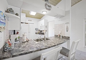 End unit condo w/two pools and steps to beach