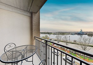 Historic district condo with private riverfront balcony, walk to shops & dining