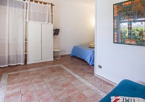 Inviting cottage with charming outdoor area and limited sea view.