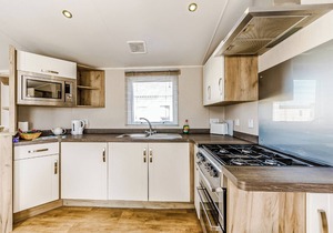 Modern and contemporary 12ft-wide caravan with one double and two twin.
