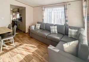 Modern and contemporary 12ft-wide caravan with one double and two twin.