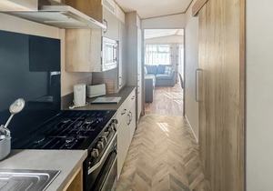 Modern and contemporary 12ft-wide caravan with one double and two twin.