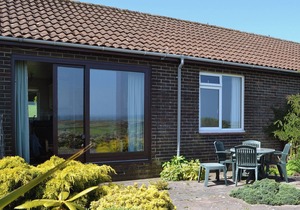 Part of a small terrace of bungalows with uninterrupted views towards the sea.