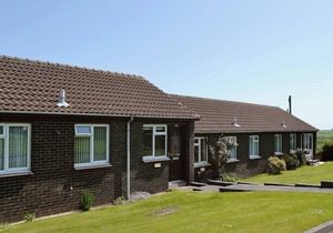Part of a small terrace of bungalows with uninterrupted views towards the sea.