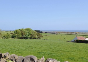 Part of a small terrace of bungalows with uninterrupted views towards the sea.