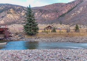 Riverside cabin with shared hot tubs, nearby skiing, fishing, and much more!