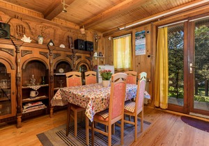 Surrounded by pine trees is this small cottage.