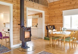 The cottage has an open floor plan and is located in the countryside.