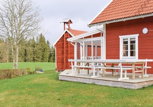 The cottage has an open floor plan and is located in the countryside.