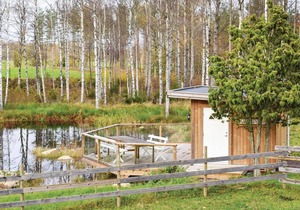 The cottage has an open floor plan and is located in the countryside.