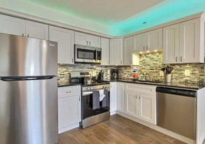 Walk to the Beach and More from this Fully Renovated Unit W/Heated Pool