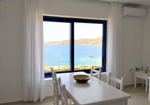 Windmill and houses by the sea / Stavros Bay