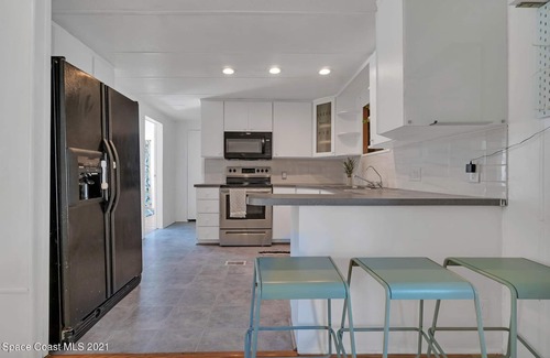 Cocoa House | 3 bed/2 bath house with tropical backyard, pool, fenced yard, hammock