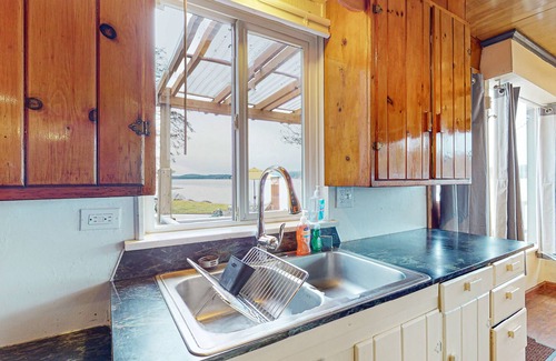 Rollingbay House | Amazing waterfront home with dock, lanai, W/D, & dog-friendly