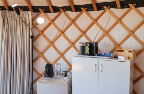 Palm Beach Cabin | Awaawa Yurts - Rangi Yurt - Awaawa Yurts offer a luxury glamping experience on Waiheke Island. Stunning views, luxury queen sized bed, private bathroom with tea and coffee making facilities.