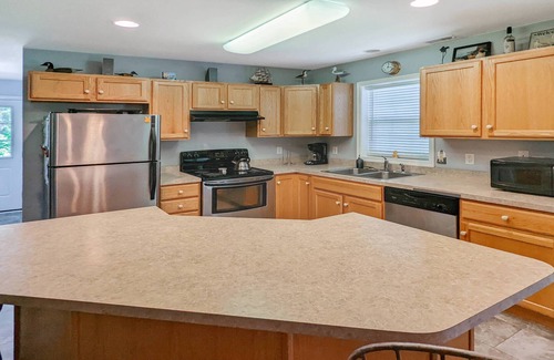 Piney Island House | Blue Heron, modern beach retreat with outdoor shower and screened porch