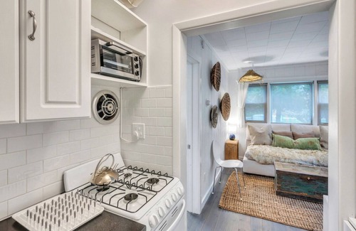 Montauk House | Bohemian-style hotel unit with ample natural light, a cozy seating area,.