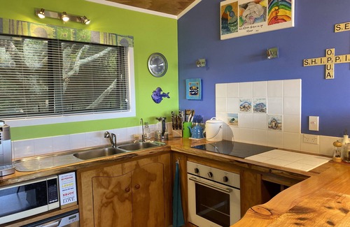 Ahipara House | "Breakview" - quiet, comfortable bach with a spa pool, for families and surfers.