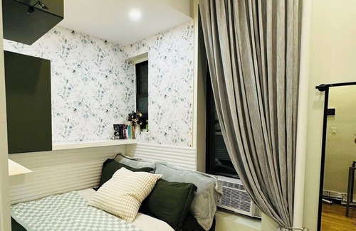 Central Park South Apartment | Charming 1 bedroom apartment in New York City featuring a shared bathroom.
