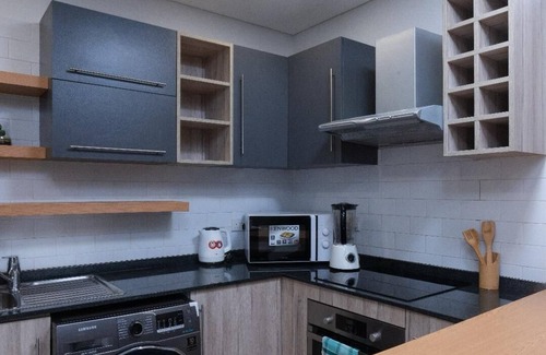East Legon Apartment | Chic 1-bedroom apartment with fitness room and AC in vibrant Accra