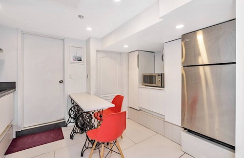 East Danforth House | Clean, white, bright and close to Woodbine subway