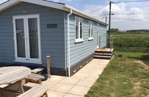 Heacham Cabin | Contemporary Beach Lodge With Sand Dunes And River Views