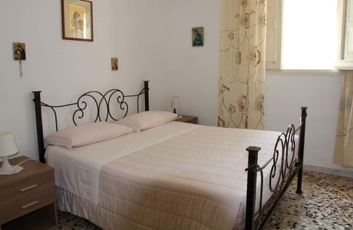 Brindisi House | cottage surrounded by trees and flowers
