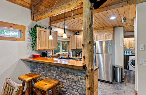 Snoqualmie Pass Cabin | Dog-friendly riverfront cabin with deck, hot tub, gas fireplace, & sauna