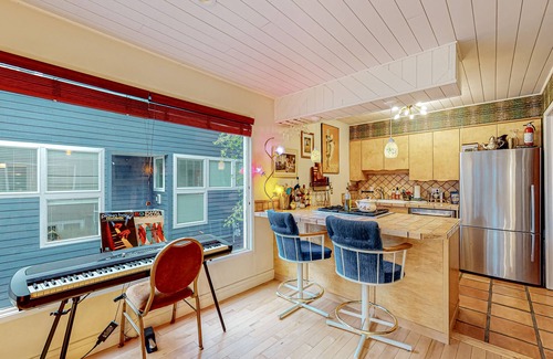 South Addition Apartment | Downtown, art-filled apartment with fireplace, balcony, & well-equipped kitchen