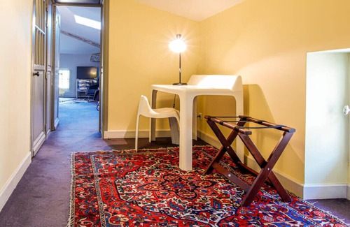 Saint-Michel Bed & Breakfast | Elegant and warm gray attic suite, decorated with its zebra carpet
