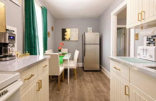 Tremont House | Emerald Oasis: Tremont 4BR Duplex by Christmas Story House | Patio, Laundry, Parking 7 Min Downtown