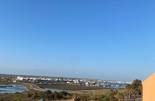 Punta del Moral Apartment | Encantador apartamento con piscina y AC primera línea de playa.