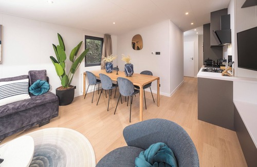Lieren House | Enjoy a luxury holiday home in the wooded nature of the Veluwe, featuring modern amenities, air conditioning, and a stylish pergola with electric fireplace for optimal comfort.