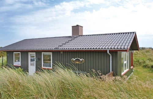 Grærup Strand House | Enjoy a relaxing holiday by the sea in this charming holiday home in the dunes.