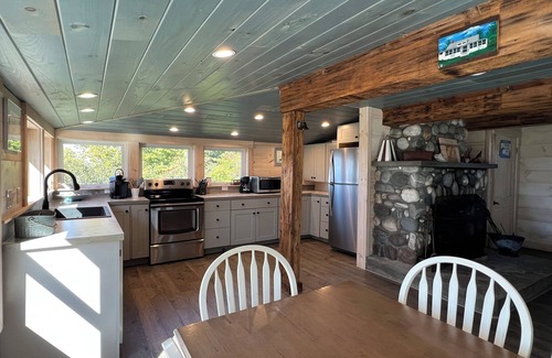 Mid-Coast and Islands House | Enjoy picturesque inlet views of a working harbor and sunny days at your oceanfront cottage