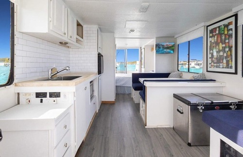 Stocking Island Boat Rental | Escape to Pineapple! Enchanting 1-bedroom house boat in George Town.