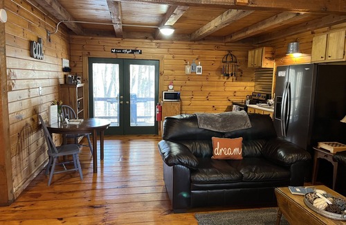 Carbon Hill Cabin | Evergreen Hideaway is a cabin nestled under tall pines.