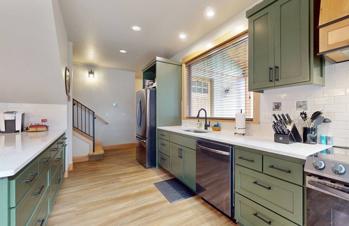 Vida House | Fully rebuilt riverfront home with deck, fireplace, & W/D - dog-friendly