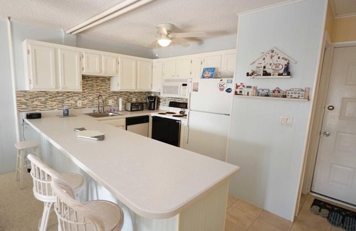 North Ocean City Condo | Fun, welcoming 2 bedroom condo with free WiFi, outdoor pool, and direct canal and bay view located midtown!