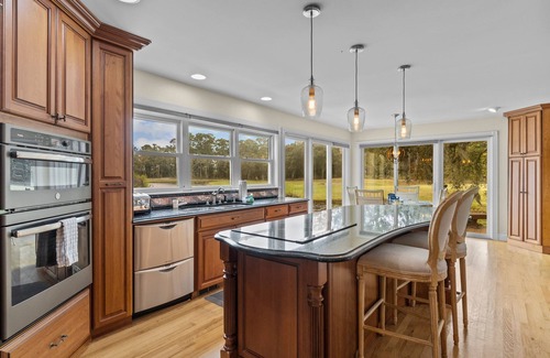 Sea Trail House | Gorgeous waterfront home with private hot tub, pool, views, deck, & fireplace