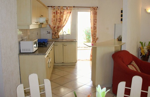 Midlands Apartment | green setting, with pool and beach nearby.