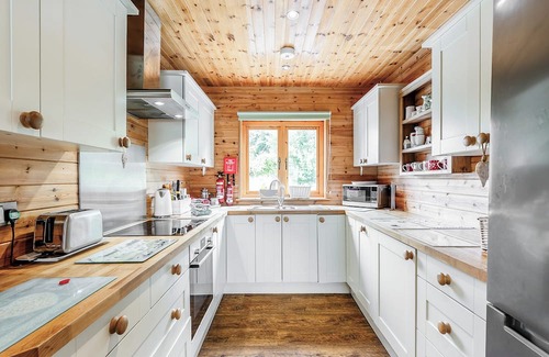 Menai Bridge Ski Chalet | Ground floor: Spacious open plan lounge, kitchen, dining area with log burner.