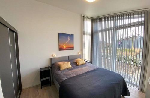 Wemeldinge House | Home with modern interior with air conditioning and view of the forest.