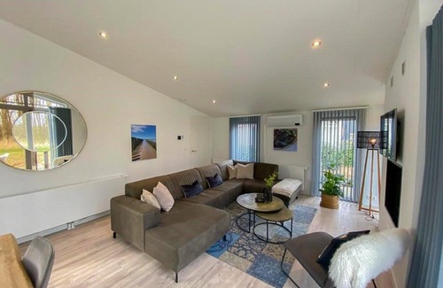 Wemeldinge House | Home with modern interior with air conditioning and view of the forest.