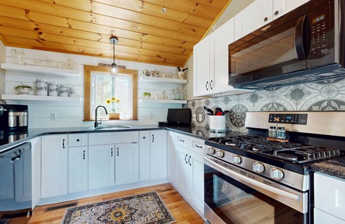 Manchester House | Idyllic & sunny lakefront home with large patio & views - near golf & skiing